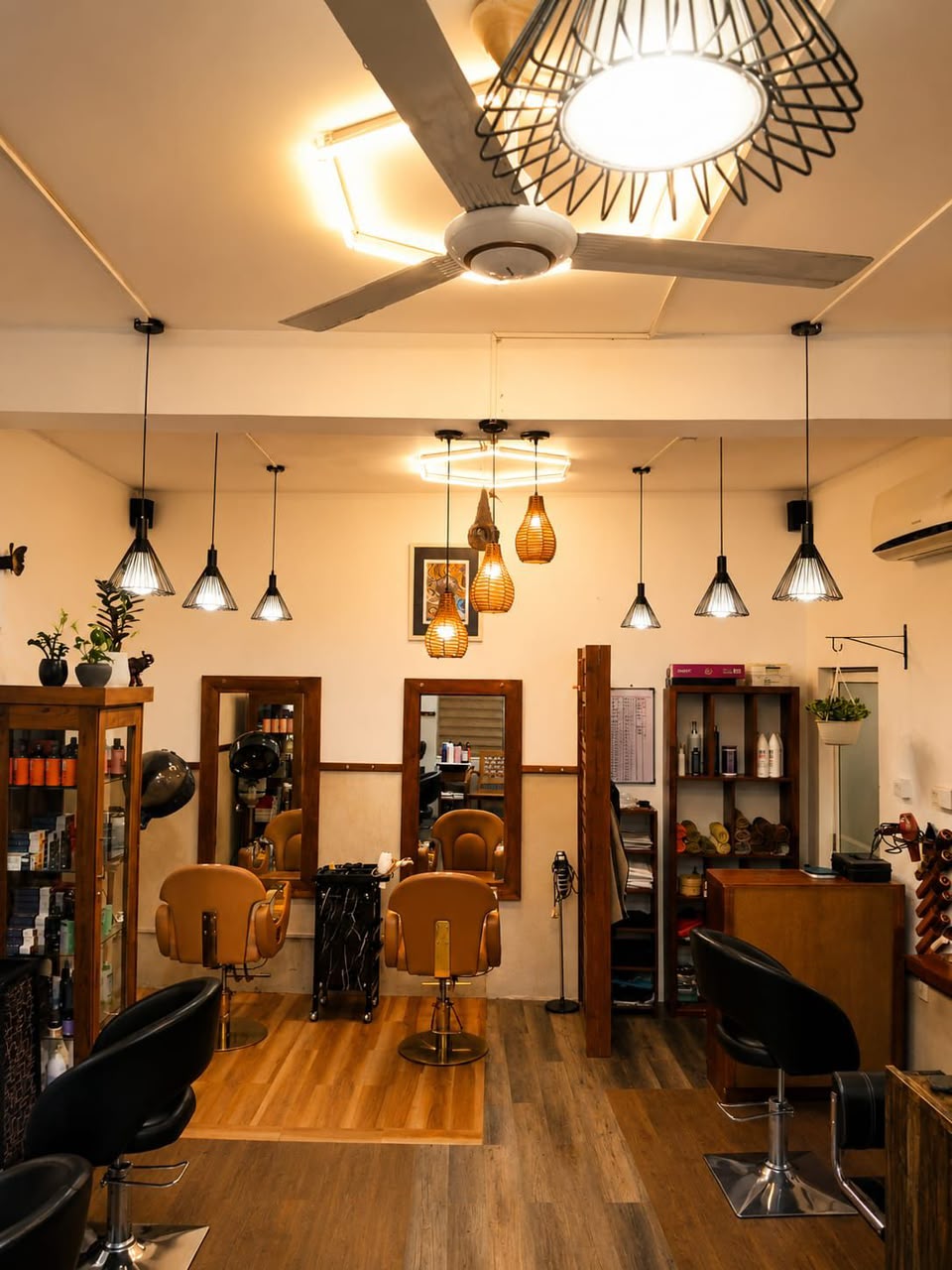 Cutting Crew barber stations beneath warm pendant lighting